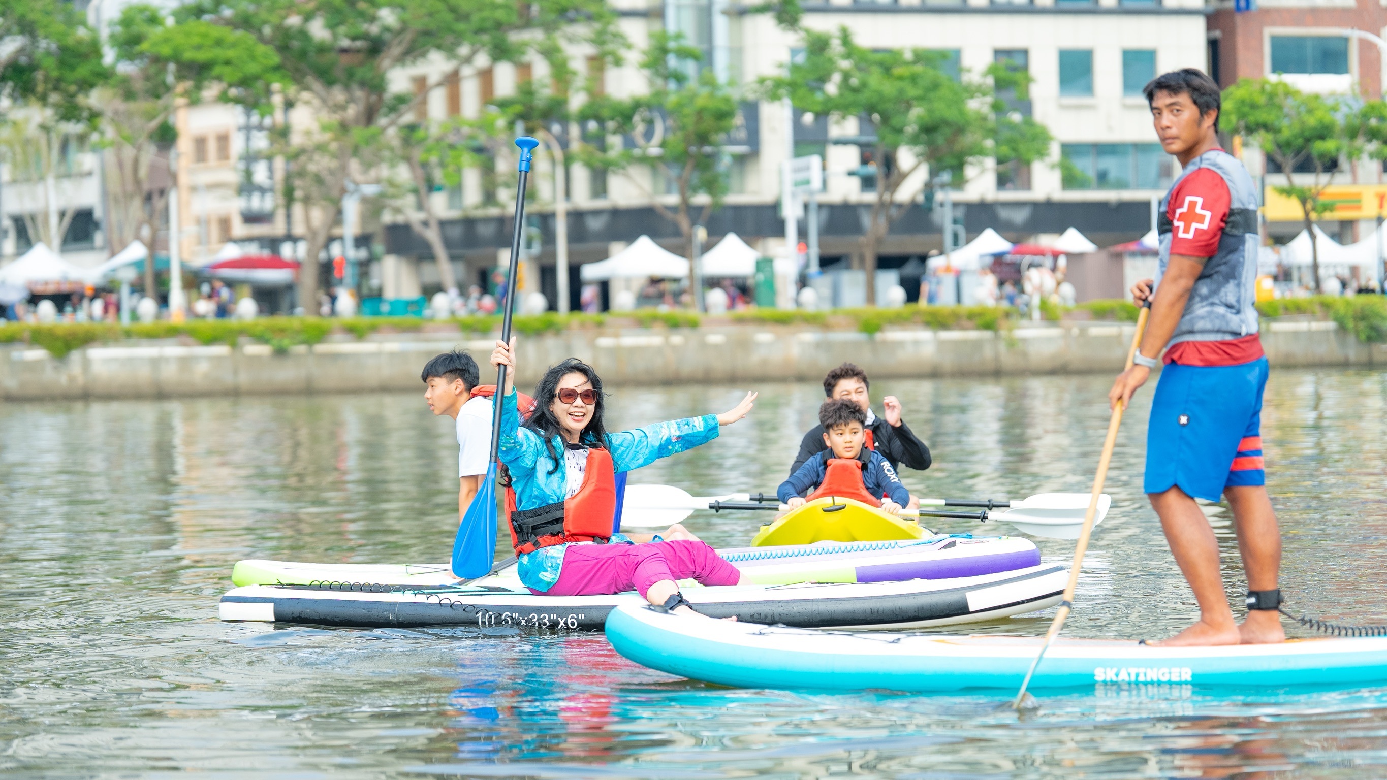 高雄端午嘉年華周邊活動，包含親子龍舟、SUP體驗與玩水氣墊，大小朋友玩得不亦樂乎。高雄市運發局提供