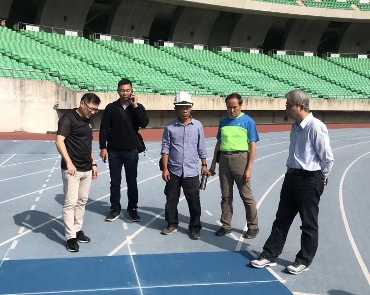 高雄市政府運動發展局局長程紹同在相關人員陪同下巡視國家體育場田徑跑道等修繕情形。高雄市運動發展局提供