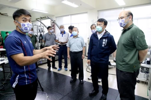 高展宏(左)、顏克典副教授(右1)向運發局長侯尊堯(右2)、體育總會理事長許文宗(右3)等說明透過運科儀器輔助,可協助避免運動傷害。高雄運發局提供
