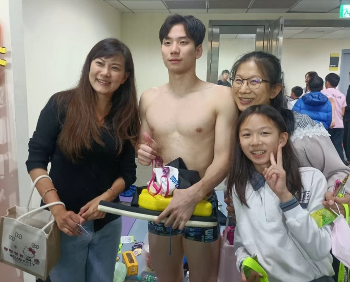前職棒球員蔡仲南老婆(左)也奉兒女之命跟王冠閎要簽名和拍照。中華民國游泳協會提供