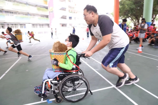 新莊丹鳳國小葉治廷導師與陳同學一起推著山豬跑。新北市政府體育處提供