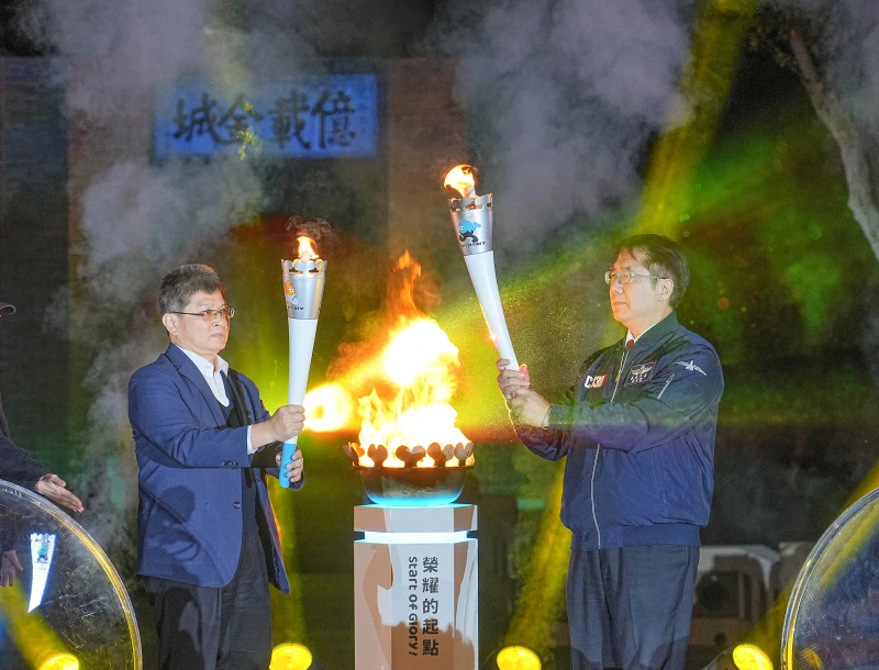 臺南市長黃偉哲(右)與體育署副署長房瑞文在億載金城前共同引燃聖火。臺南市體育局提供