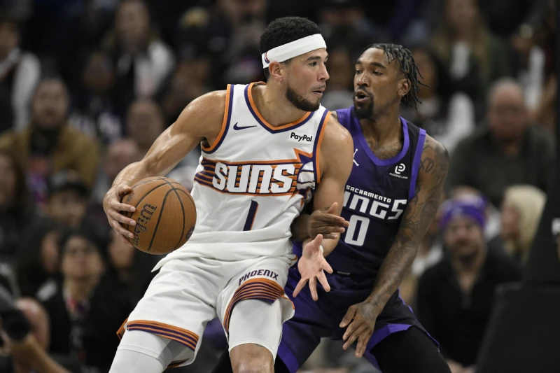 太陽得分王Devin Booker（平均25分，左）因鼠蹊傷缺席第二場。法新社