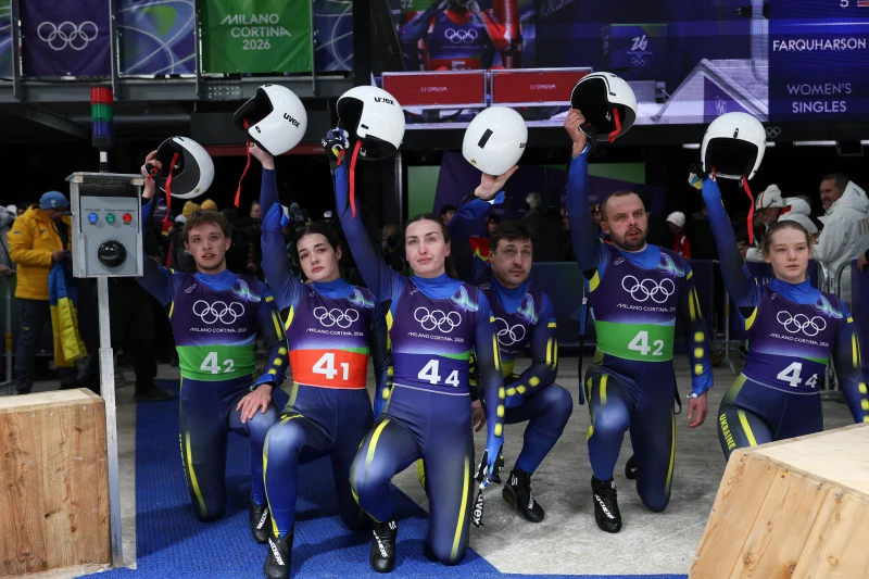 烏克蘭選手參賽前跪地舉盔向被禁賽的空架雪車選手赫拉斯克維奇(Vladyslav Heraskevych)致意。法新社